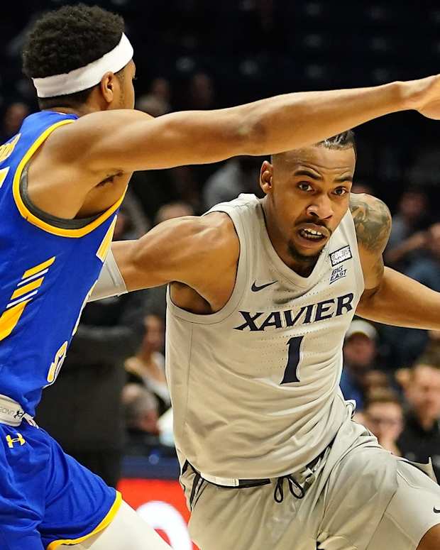 Xavier Musketeers guard Paul Scruggs (1) drives to the basket as Morehead State Eagles guard Ta'lon Cooper (55) defends in the second half of an NCAA college basketball game, Wednesday, Dec. 15, 2021, at Cintas Center in Cincinnati. The Xavier Musketeers defaced the Morehead State Eagles, 86-63.

Morehead State Eagles At Xavier Musketeers Dec 15